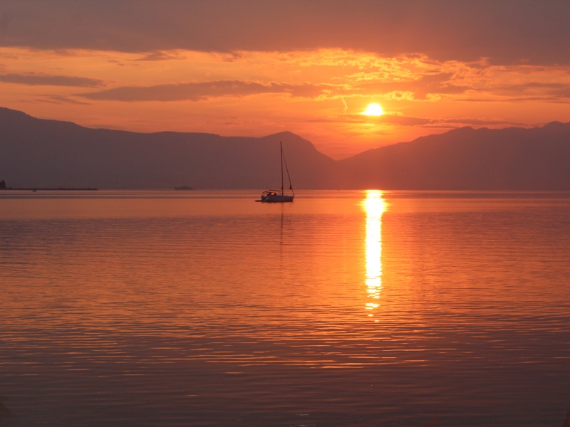 Picturesque sunset and a lone sailboat off the coast of trogir, Motorcycle Rental Agency Trogir Croatia