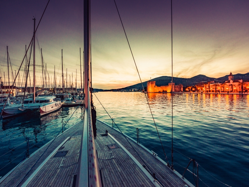 Sailboat arriving in port trogir at sunset, Motorcycle Rental Agency Trogir Croatia