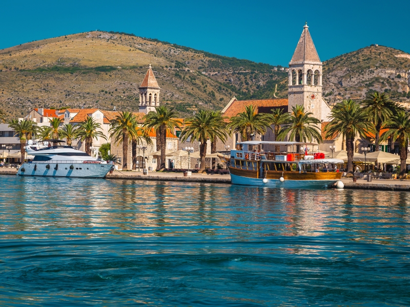 Spectacular waterfront promenade with palm trees and street cafes in trogir, Motorcycle Rental Agency Trogir Croatia