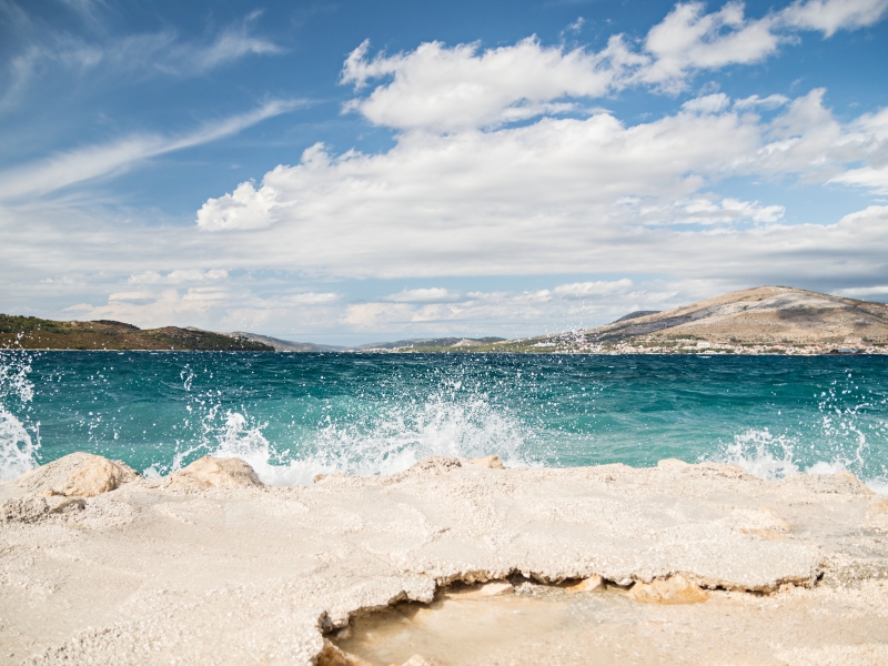 Waves of the sea crash against the rocky shore somewhere across the adriatic, Motorcycle Rental Agency Trogir Croatia